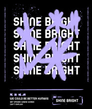 Load image into Gallery viewer, Graffiti style with stars in purple and white text saying Shine Bright beneath in a black box. Pink Runway design girls t shirt.