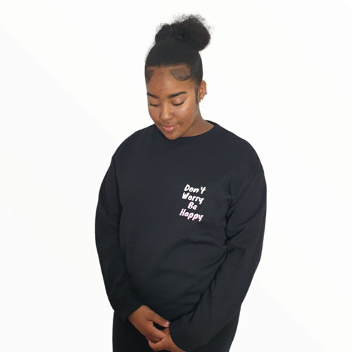 Girl pictured wearing black 'Don't Worry Be Happy' sweatshirt from Pink Runway's Bright Future range.